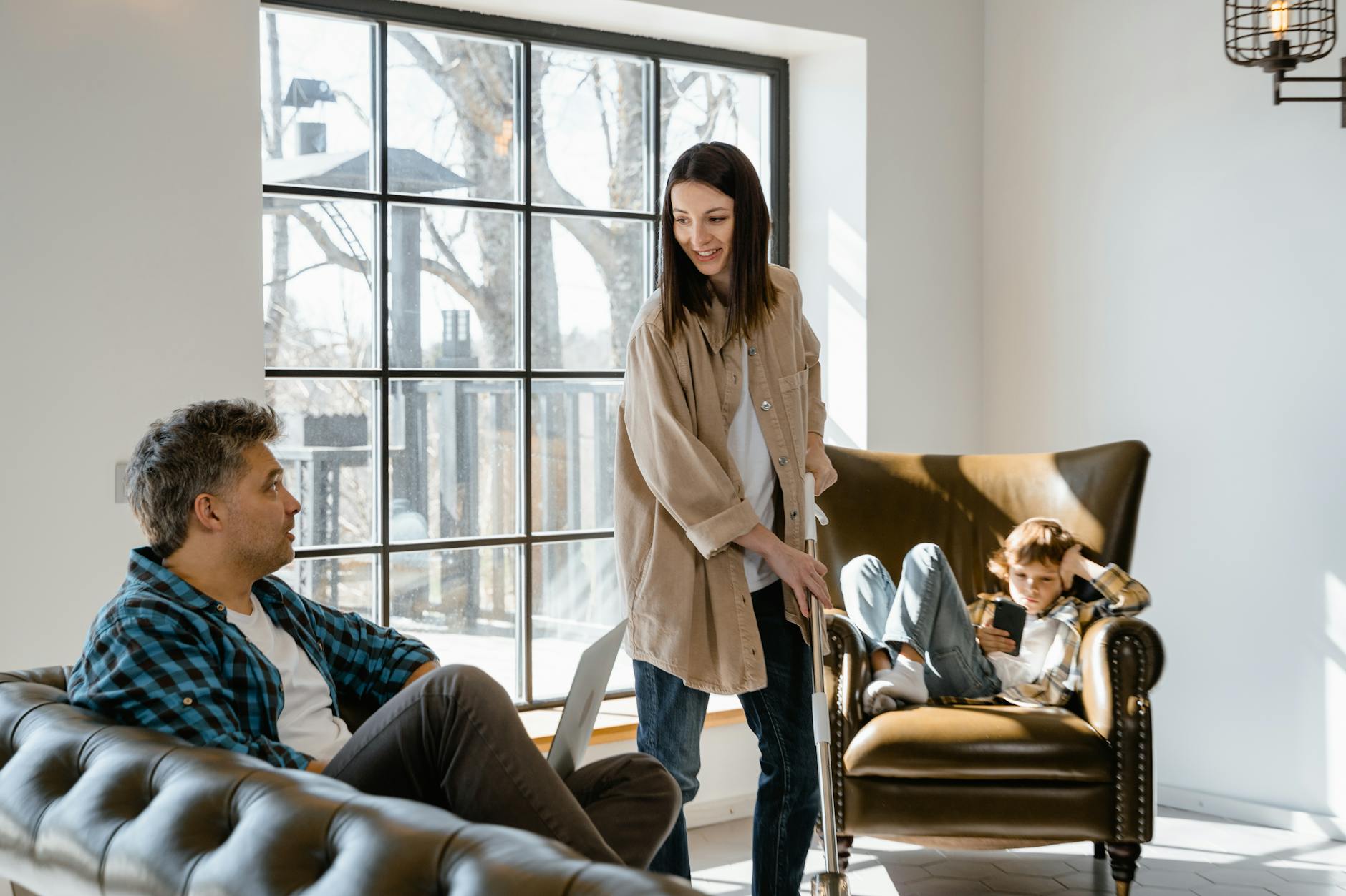 Uśmiechnięta rodzina spędza czas w jasnym salonie