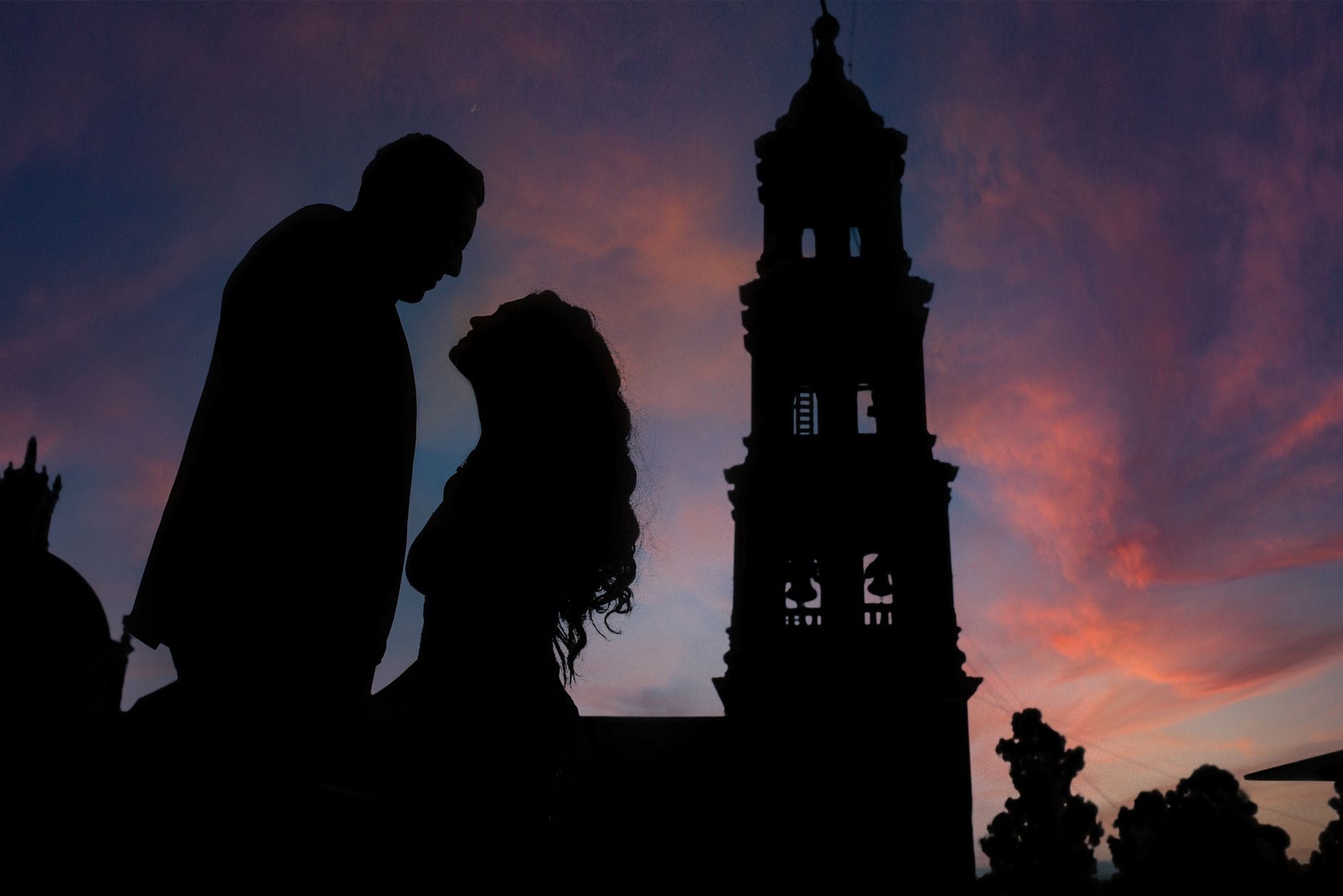 Sylwetki zakochanej pary o zachodzie słońca na tle kościoła w Guanajuato Sylwetki zakochanej pary o zachodzie słońca na tle kościoła w Guanajuato